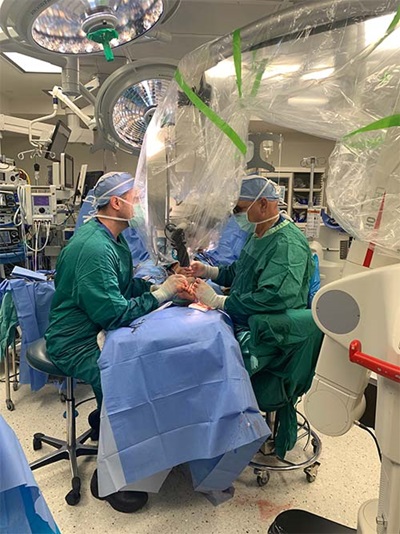 Dr. Levin and Dr. Steinberger working in an operating room